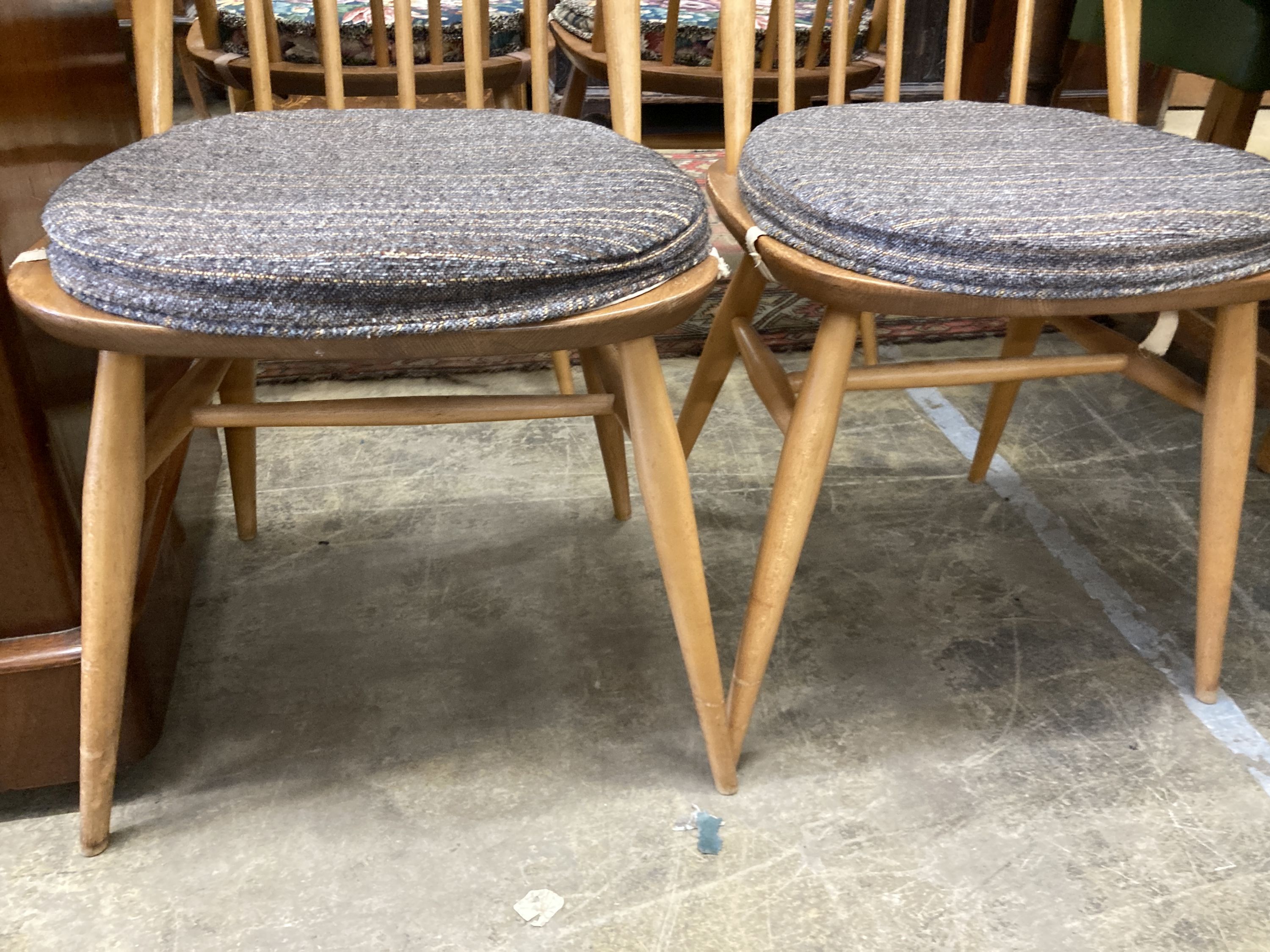 A set of four Ercol light beech comb back Windsor dining chairs